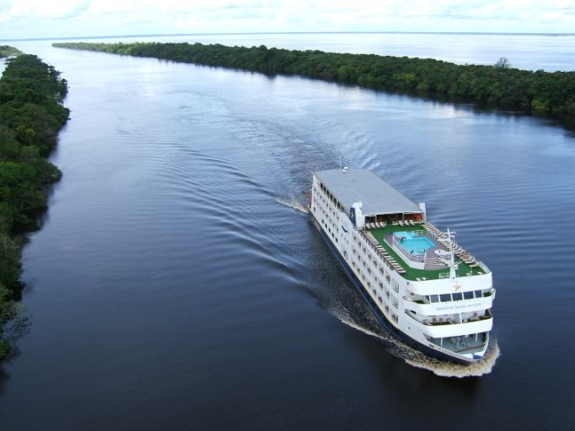 Iberostar Grand Amazon navegando pelo rio Amazonas rodeado por floresta